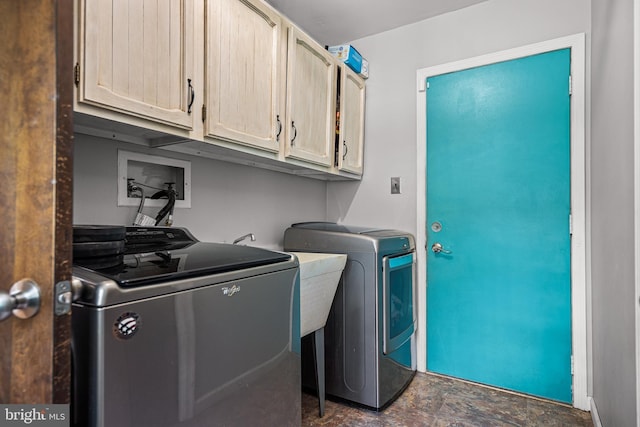 washroom with cabinets and separate washer and dryer