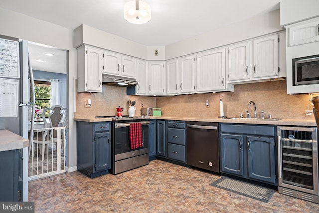 kitchen with appliances with stainless steel finishes, blue cabinets, white cabinetry, sink, and wine cooler