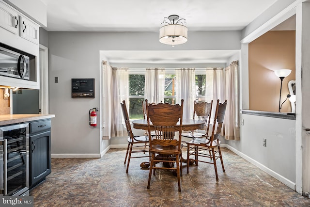 dining space with wine cooler and bar