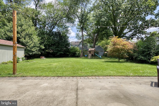 view of yard with a patio and a playground