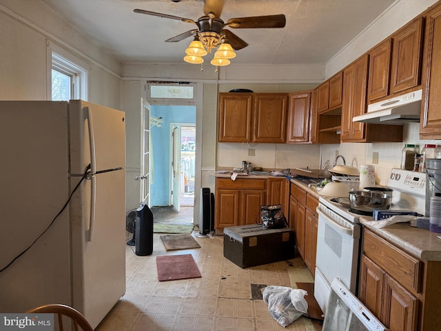 kitchen with white appliances, ceiling fan, and backsplash