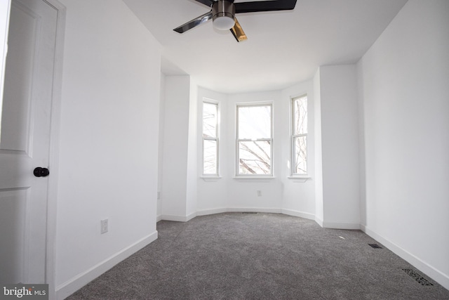 carpeted spare room with ceiling fan