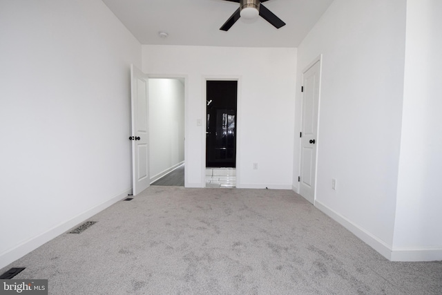 empty room featuring carpet floors and ceiling fan