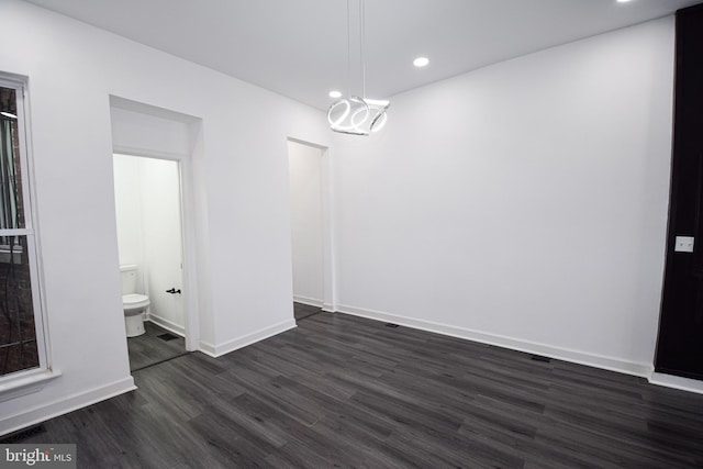 unfurnished dining area featuring dark wood-type flooring