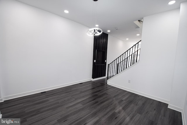 spare room with dark hardwood / wood-style flooring