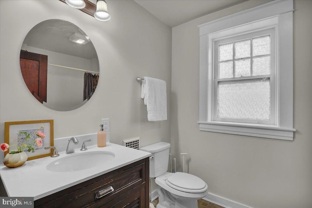 bathroom featuring vanity, a shower with curtain, and toilet