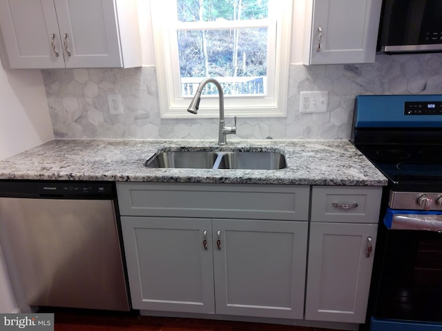 kitchen featuring white cabinetry, sink, and appliances with stainless steel finishes