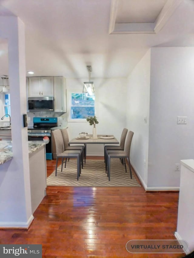 dining room featuring dark hardwood / wood-style flooring and sink