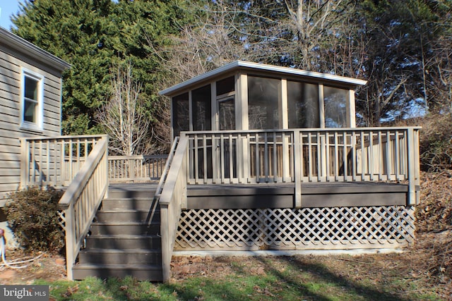 back of house featuring a sunroom and a deck