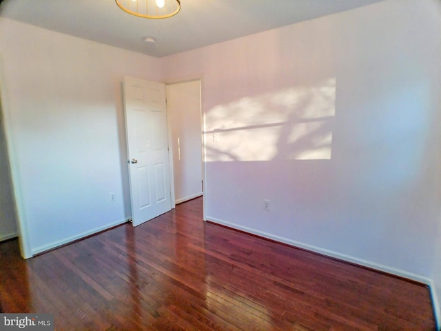 spare room featuring dark wood-type flooring