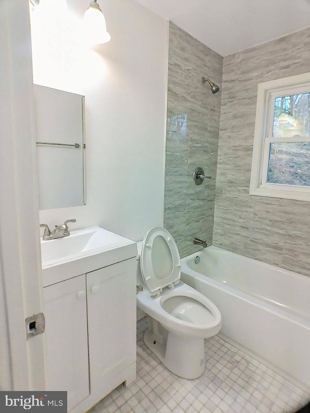 full bathroom with vanity, toilet, and tiled shower / bath combo