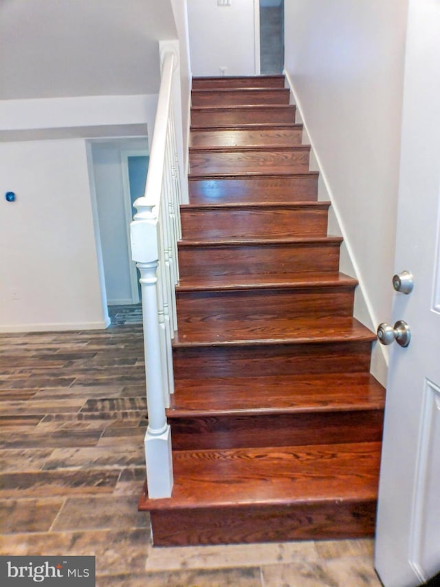 staircase with hardwood / wood-style flooring