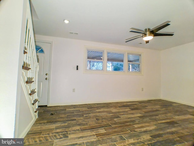 empty room with dark hardwood / wood-style floors and ceiling fan