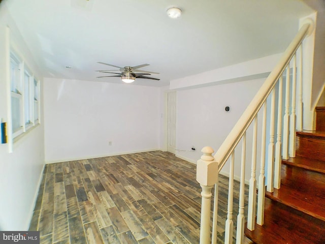 empty room featuring dark wood-type flooring and ceiling fan