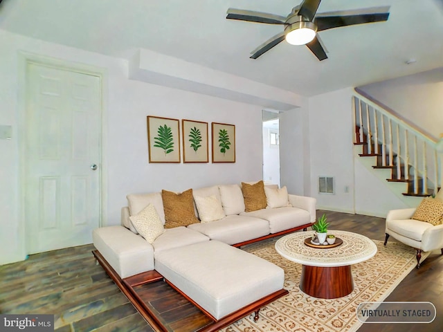 living room featuring dark hardwood / wood-style floors and ceiling fan