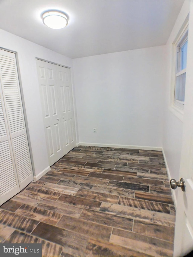 unfurnished bedroom with two closets