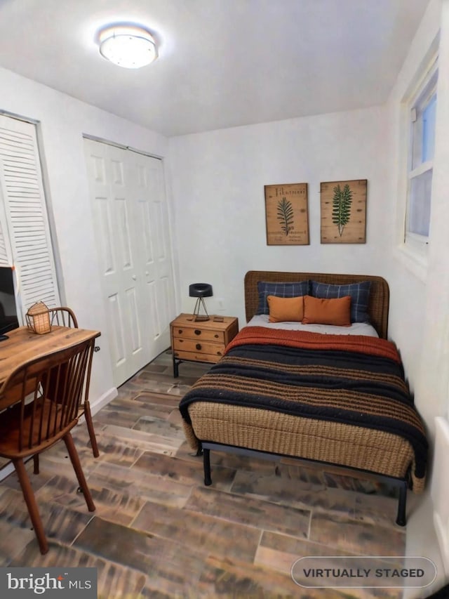 bedroom with dark hardwood / wood-style flooring