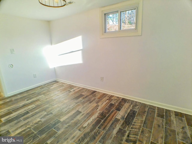 unfurnished room featuring dark wood-type flooring