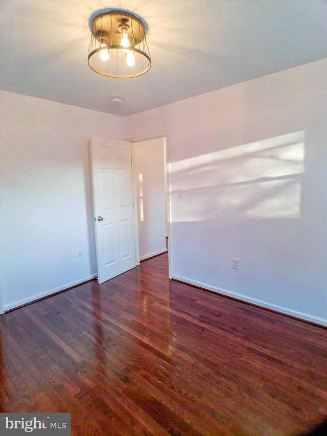 unfurnished room featuring dark hardwood / wood-style flooring