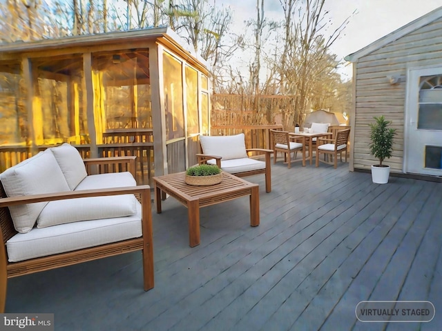 wooden deck featuring an outdoor hangout area and a sunroom