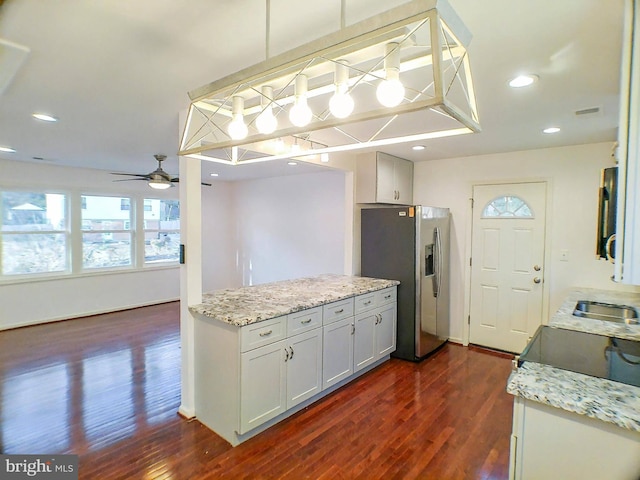 kitchen featuring stainless steel refrigerator with ice dispenser, pendant lighting, dark hardwood / wood-style flooring, and white cabinets