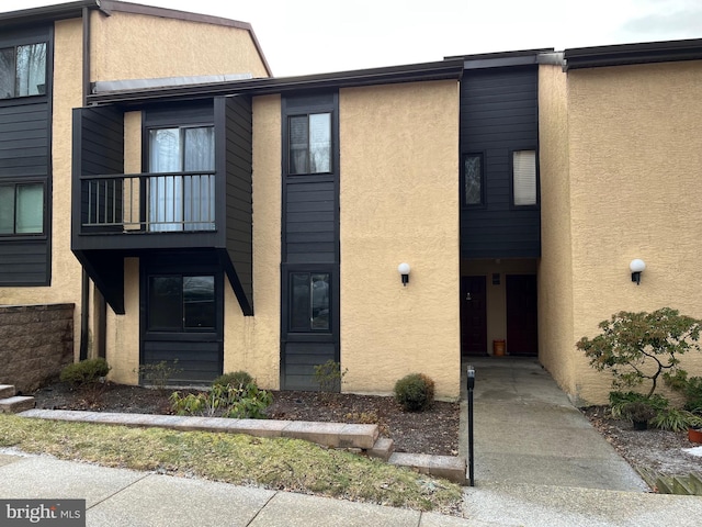 view of front of property with a balcony