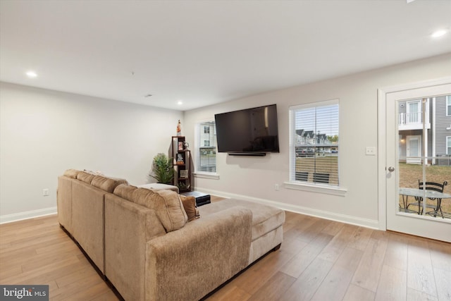 living room with recessed lighting, light wood-style flooring, and baseboards