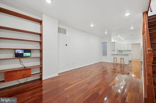 unfurnished living room with hardwood / wood-style floors