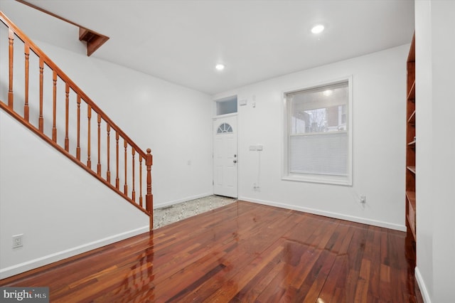 entrance foyer with dark hardwood / wood-style floors