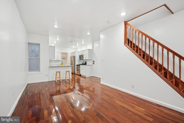 unfurnished living room with wood-type flooring