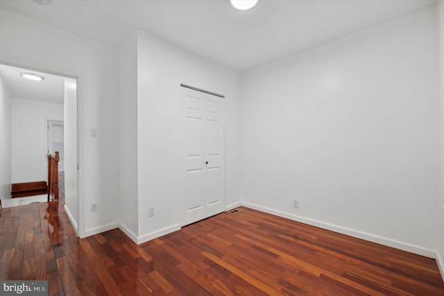 unfurnished room with dark hardwood / wood-style floors