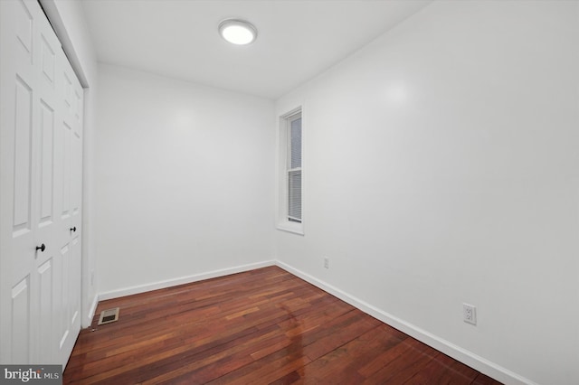 spare room featuring dark hardwood / wood-style flooring