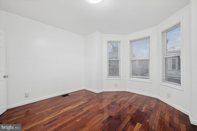 empty room with dark wood-type flooring