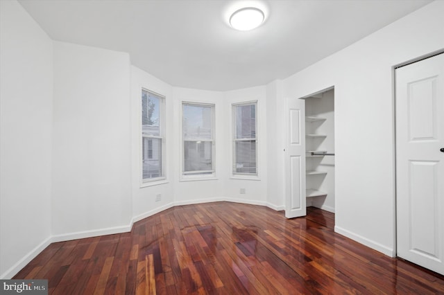 unfurnished bedroom featuring dark hardwood / wood-style floors