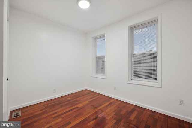 empty room featuring dark wood-type flooring