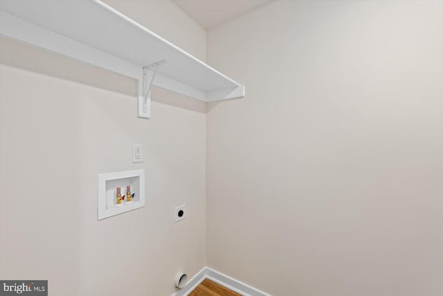 clothes washing area featuring hookup for a washing machine, hookup for an electric dryer, and hardwood / wood-style flooring