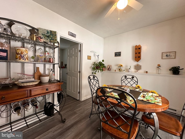 dining room with dark hardwood / wood-style floors, a textured ceiling, and ceiling fan