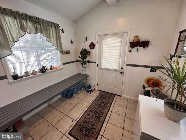 tiled entryway with lofted ceiling