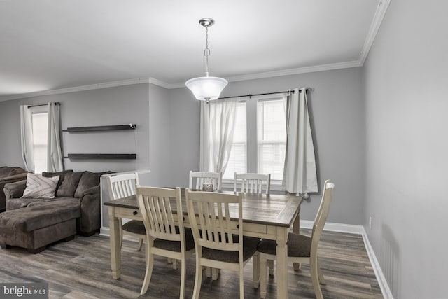 dining room featuring ornamental molding, plenty of natural light, and dark hardwood / wood-style floors