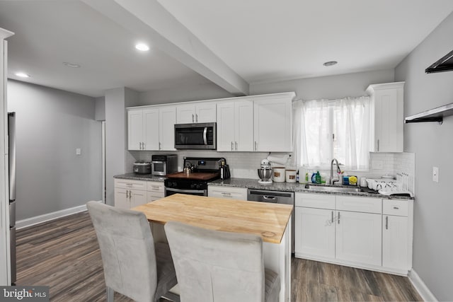 kitchen featuring stainless steel appliances, white cabinetry, dark hardwood / wood-style floors, and wood counters