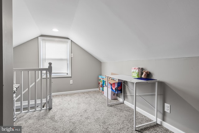 interior space with lofted ceiling and carpet flooring