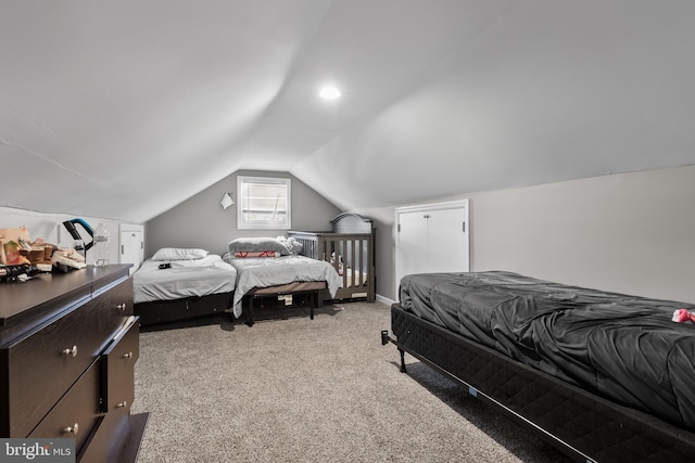 carpeted bedroom featuring lofted ceiling