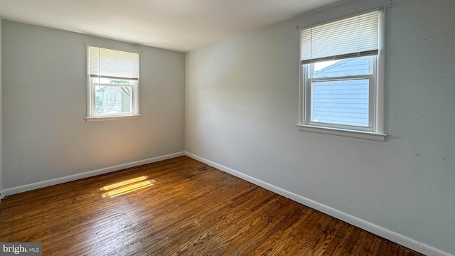 unfurnished room with wood-type flooring