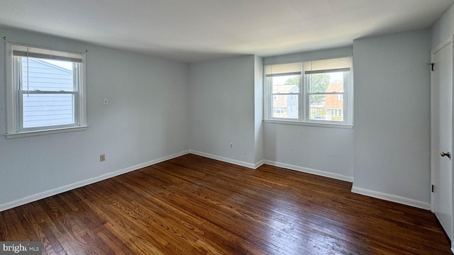 empty room featuring dark wood-type flooring