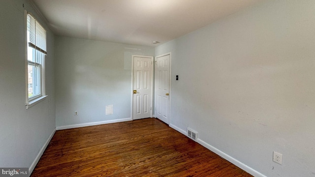 unfurnished room featuring dark hardwood / wood-style flooring