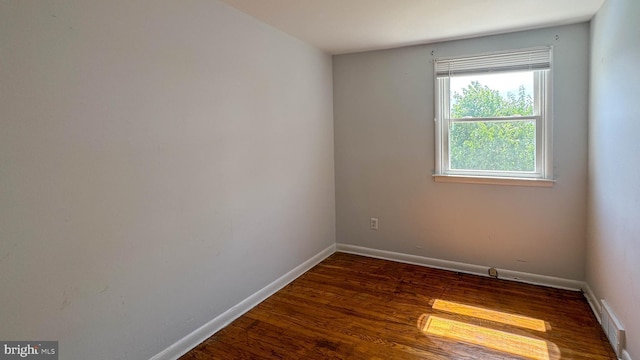 spare room featuring dark hardwood / wood-style flooring