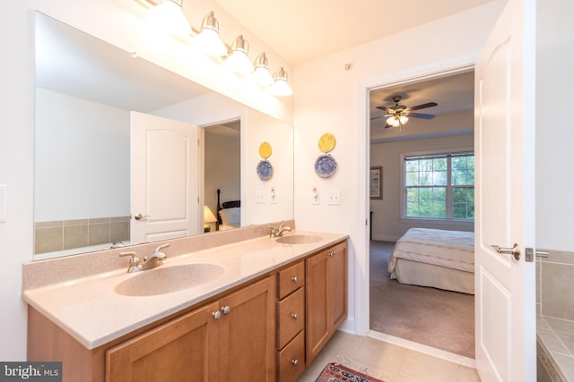 bathroom with tile patterned flooring, vanity, and ceiling fan