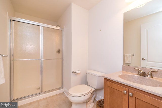 bathroom featuring a shower with door, vanity, and toilet