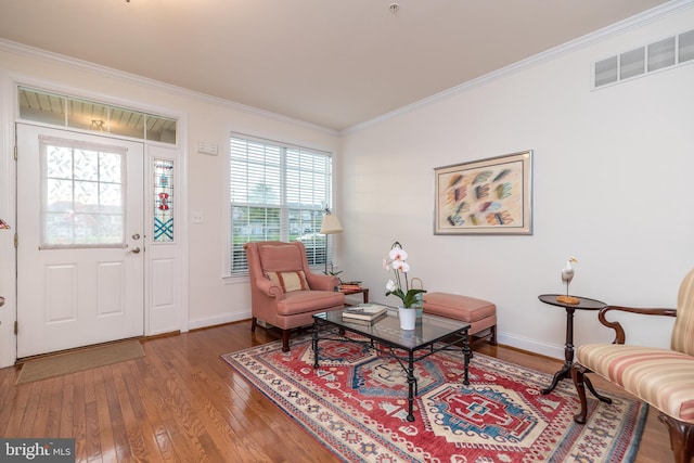 entrance foyer featuring hardwood / wood-style flooring and crown molding