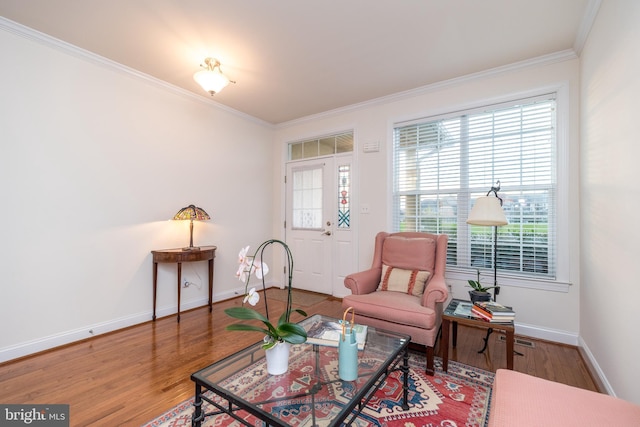 sitting room featuring hardwood / wood-style flooring, crown molding, and plenty of natural light